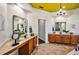 Spacious bathroom with dual sinks, wooden cabinets, decorative plants, and a chandelier at 2626 Greenwillow Dr, Orlando, FL 32825