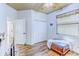 Bright bedroom with wood floors, a closet, and a window, offering a simple and functional space at 2626 Greenwillow Dr, Orlando, FL 32825
