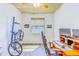 Functional bedroom featuring a bicycle on a rack, a workstation, and a window with natural light at 2626 Greenwillow Dr, Orlando, FL 32825