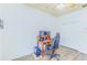 Spacious bedroom featuring a ceiling fan, a workstation with dual monitors, and a large closet at 2626 Greenwillow Dr, Orlando, FL 32825