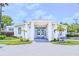 The clubhouse entrance features classic architectural lines, a brick walkway, and pretty landscaping at 2626 Greenwillow Dr, Orlando, FL 32825