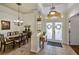 Elegant dining room boasting tile floors, an ornate chandelier, and decorative frosted glass doors at 2626 Greenwillow Dr, Orlando, FL 32825