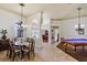 Spacious dining room with tile flooring flowing into a living space with stylish billiard table at 2626 Greenwillow Dr, Orlando, FL 32825