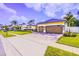 Lovely home with well-kept landscaping, a paved driveway, and lush green lawn at 2626 Greenwillow Dr, Orlando, FL 32825