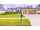 Beautiful single-Gathering home with a well-manicured lawn and a three-car garage at 2626 Greenwillow Dr, Orlando, FL 32825