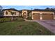 Stunning home exterior featuring a three-car garage and beautifully landscaped front yard at 2626 Greenwillow Dr, Orlando, FL 32825