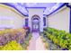 Inviting front entrance with a brick walkway and lush landscaping at 2626 Greenwillow Dr, Orlando, FL 32825