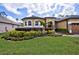 Lush landscaping compliments the front yard and facade of this beautiful single Gathering home at 2626 Greenwillow Dr, Orlando, FL 32825