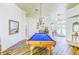 Game room features a pool table, chandelier, and beautiful flooring at 2626 Greenwillow Dr, Orlando, FL 32825