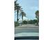 View of the community gate lined with mature palms at 2626 Greenwillow Dr, Orlando, FL 32825