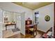 Bright office space featuring a classic wooden desk and chair, with a view to the entrance through an open door at 2626 Greenwillow Dr, Orlando, FL 32825