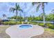 Outdoor hot tub with surrounding chairs, landscaping, and mature palm trees at 2626 Greenwillow Dr, Orlando, FL 32825
