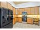 Bright kitchen featuring wood cabinets, granite countertops, and stainless steel appliances at 2626 Greenwillow Dr, Orlando, FL 32825
