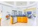 Open-concept kitchen with breakfast bar, stainless steel appliances, granite countertops, and adjacent living area at 2626 Greenwillow Dr, Orlando, FL 32825