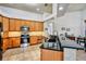 Spacious kitchen with black countertops, ample wood cabinetry, stainless steel appliances, and tile flooring at 2626 Greenwillow Dr, Orlando, FL 32825