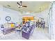 Open-concept living room featuring a leather sofa, armchairs, and seamless transition to kitchen and dining area at 2626 Greenwillow Dr, Orlando, FL 32825