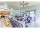 Bright living area boasts hardwood floors, modern furnishings, with kitchen and dining area, and sliding glass doors at 2626 Greenwillow Dr, Orlando, FL 32825