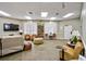 Inviting community lounge area with cozy seating, a bookshelf, and large windows providing natural light at 2626 Greenwillow Dr, Orlando, FL 32825