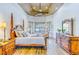 Bright main bedroom showcases detailed furniture, warm wood floors, and many windows at 2626 Greenwillow Dr, Orlando, FL 32825