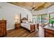 Elegant main bedroom features a tray ceiling, wood floors, and an abundance of natural light at 2626 Greenwillow Dr, Orlando, FL 32825