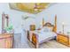 Bright main bedroom featuring wood floors, tray ceilings, and attractive wood furniture at 2626 Greenwillow Dr, Orlando, FL 32825