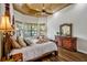Elegant main bedroom offering wood floors, a tray ceiling, and plenty of natural light from the many windows at 2626 Greenwillow Dr, Orlando, FL 32825