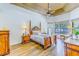 Spacious main bedroom with wood-look tile flooring, decorative ceiling, and plenty of natural light at 2626 Greenwillow Dr, Orlando, FL 32825