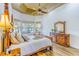 Bright main bedroom showcases detailed furniture, warm wood floors, and many windows at 2626 Greenwillow Dr, Orlando, FL 32825