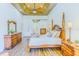 Bright main bedroom featuring wood floors, tray ceilings, and attractive wood furniture at 2626 Greenwillow Dr, Orlando, FL 32825