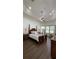 This primary bedroom has wood floors, tray ceiling, fan, and windows with a view at 2626 Greenwillow Dr, Orlando, FL 32825