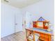 Bright office space boasts wood floors and a well-lit desk area, leading to additional rooms at 2626 Greenwillow Dr, Orlando, FL 32825