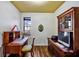 Well-lit home office space with a classic wooden desk, built-in storage, and hardwood floors at 2626 Greenwillow Dr, Orlando, FL 32825