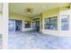 Covered patio with tiled floor, ceiling fan and multiple access points to the interior of the home at 2626 Greenwillow Dr, Orlando, FL 32825