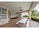 Covered patio with picnic tables and ceiling fans for outdoor relaxation at 2626 Greenwillow Dr, Orlando, FL 32825