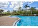 Sparkling community pool with a brick surround, palm trees, and ample space for relaxation and recreation at 2626 Greenwillow Dr, Orlando, FL 32825