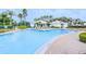 Large outdoor community pool surrounded by lounge chairs and palm trees at 2626 Greenwillow Dr, Orlando, FL 32825