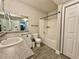 This bathroom features granite counters, tile floors, shower and large vanity mirror at 304 E South St # 1023, Orlando, FL 32801