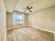 This bedroom features modern ceiling fan, stylish wood-look floors, and a bright window at 304 E South St # 1023, Orlando, FL 32801