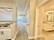 Hallway view with a kitchen counter, doorway to a bathroom, and sliding glass patio door at 304 E South St # 1023, Orlando, FL 32801