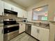 Featuring stainless steel appliances, white cabinets, and tile backsplash at 304 E South St # 1023, Orlando, FL 32801