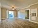 Large living room with wood-look flooring, ceiling fan, and access to an outdoor balcony at 304 E South St # 1023, Orlando, FL 32801