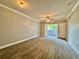 Spacious living room with wood-look flooring, ceiling fan, and access to a balcony at 304 E South St # 1023, Orlando, FL 32801