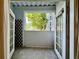 View of a screened patio with a large tree and building across from it at 304 E South St # 1023, Orlando, FL 32801