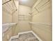 Organized walk-in closet with metal shelving and stylish wood-look tile floors at 304 E South St # 1023, Orlando, FL 32801