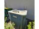 Exterior Lennox HVAC unit surrounded by greenery with garbage cans near the wall at 3301 Bethpage Loop, Mount Dora, FL 32757