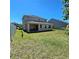 Exterior view of a backyard with a covered patio and a large play set at 3301 Bethpage Loop, Mount Dora, FL 32757