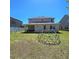 Large backyard with green dome shaped play set, covered patio, and privacy fence at 3301 Bethpage Loop, Mount Dora, FL 32757