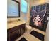 Bathroom with vanity, toilet and shower with a playful black shower curtain at 3301 Bethpage Loop, Mount Dora, FL 32757