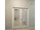 Frosted double doors lead to a bathroom with patterned glass at 3301 Bethpage Loop, Mount Dora, FL 32757