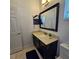 Bathroom features a vanity, toilet, and framed mirror at 3301 Bethpage Loop, Mount Dora, FL 32757